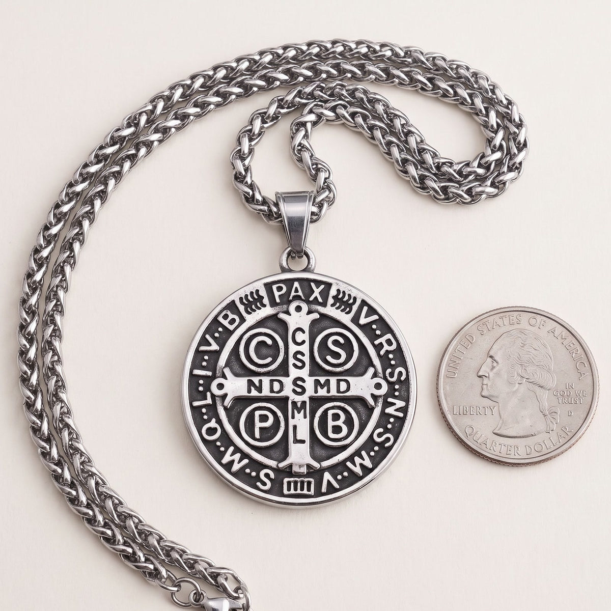 The 38 mm St Benedict medal beside a US quarter
