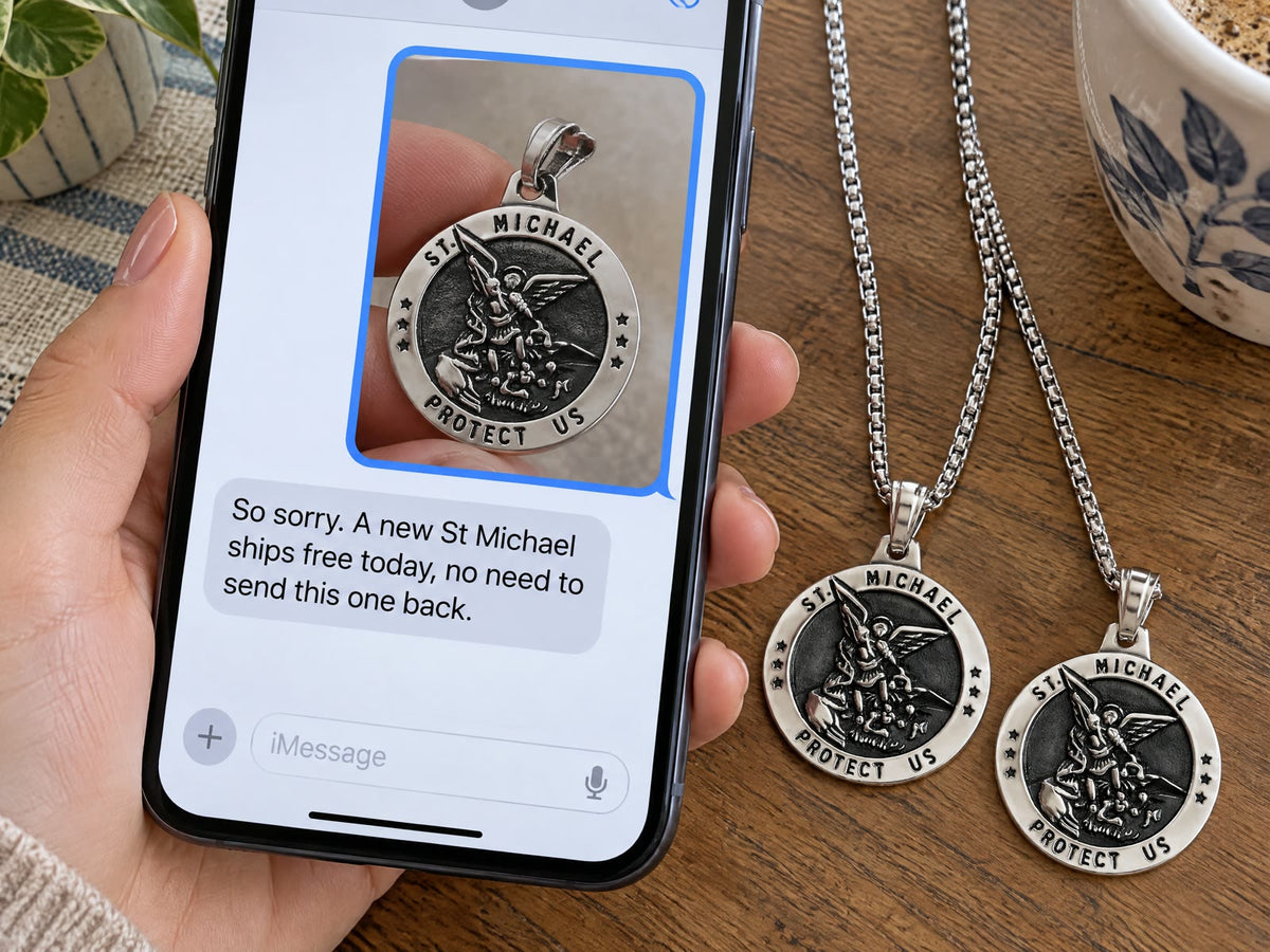 A phone showing a photo of a medal with a bent ring and the reply: So sorry. A new St Michael ships free today, no need to send this one back.