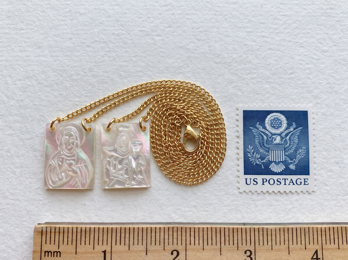 The mother-of-pearl scapular beside a quarter
