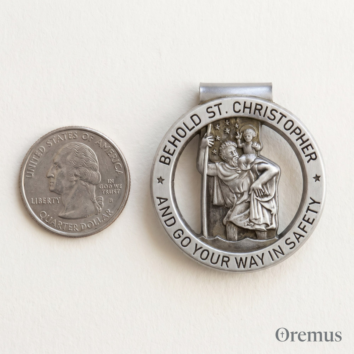 The St Christopher clip beside a quarter