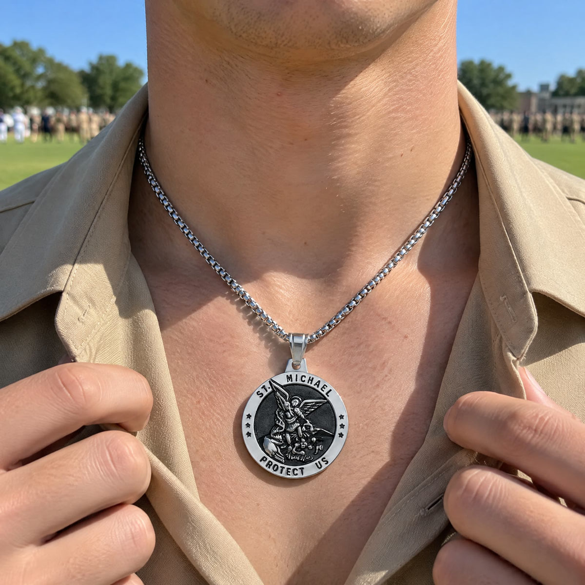 On a sunny parade field a young man opens his plain tan uniform collar, a silver St Michael medal on his chest