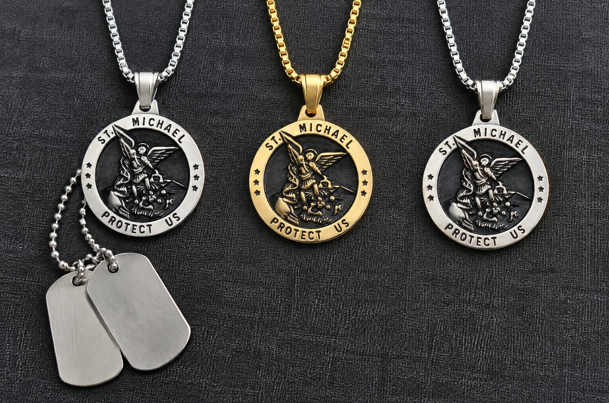 Three St Michael medals in a row on dark linen, two blank dog tags beside the first