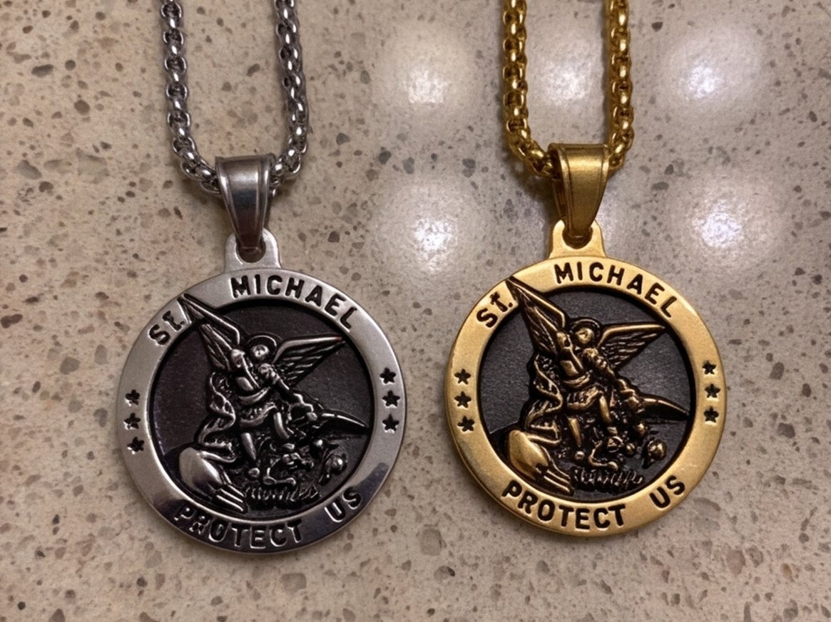A gold and a silver St Michael medal side by side on a bathroom counter
