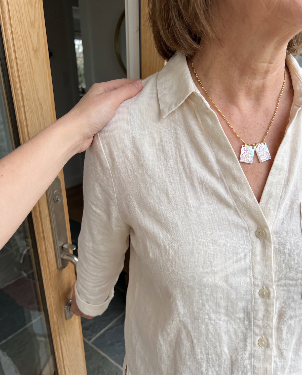 The mother-of-pearl scapular at the front door, a mother’s hand on her son